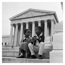 Two children sit in front of the Supreme Court
